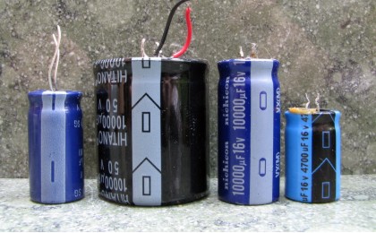 Four electrolytic capacitors showing the negative markings.